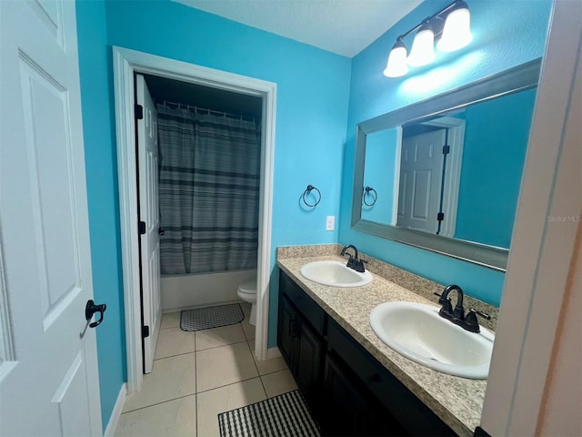 full bathroom with tile patterned flooring, vanity, shower / bath combo with shower curtain, and toilet