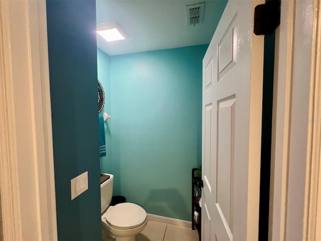 bathroom featuring tile patterned floors and toilet