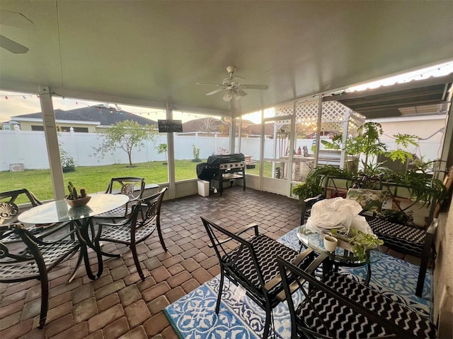 exterior space with ceiling fan and a water view