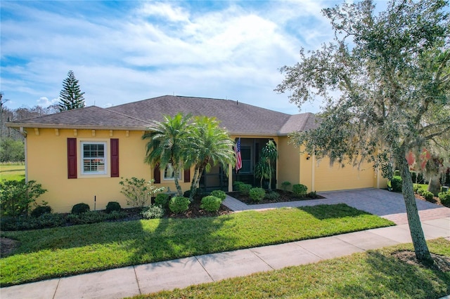 view of front of home featuring a garage and a front lawn