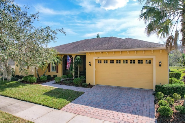 view of front of property with a garage and a front yard