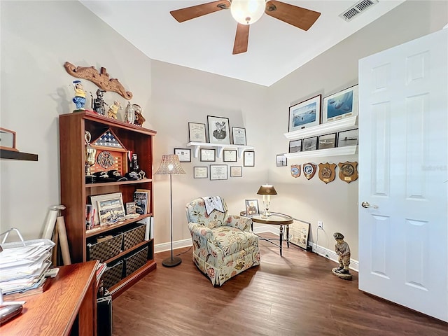 living area with ceiling fan and dark hardwood / wood-style floors