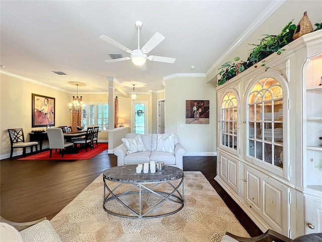 living room featuring dark hardwood / wood-style flooring, crown molding, and ceiling fan with notable chandelier