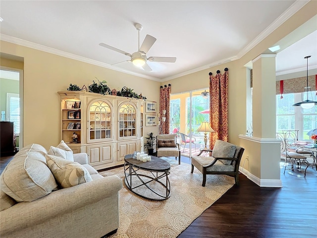 living room featuring hardwood / wood-style floors, crown molding, decorative columns, and ceiling fan