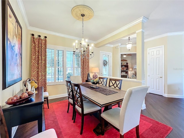 dining room with ornate columns, wood-type flooring, a chandelier, and crown molding