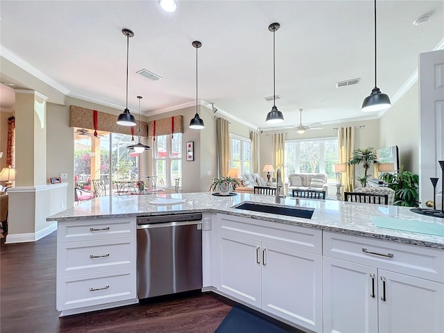 kitchen featuring white cabinetry, pendant lighting, and stainless steel dishwasher