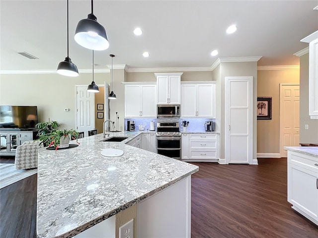 kitchen with pendant lighting, sink, stainless steel appliances, light stone countertops, and white cabinets