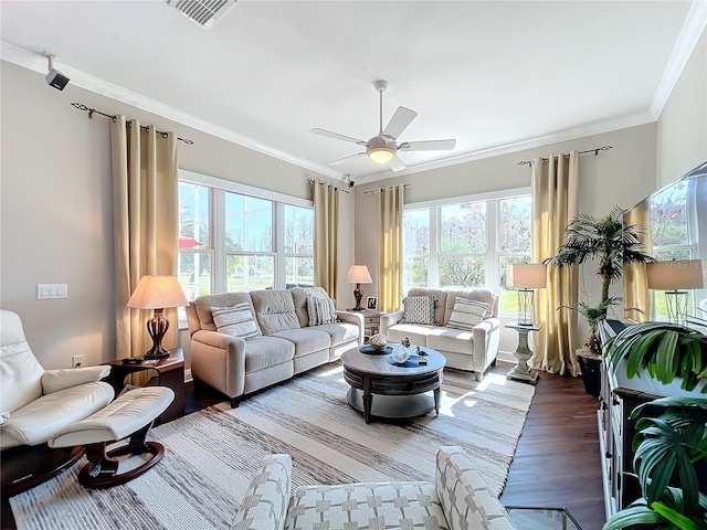 living room featuring crown molding, wood-type flooring, and ceiling fan