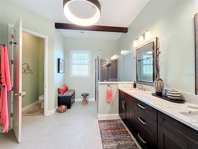 bathroom featuring vanity, a shower with shower door, beam ceiling, and toilet