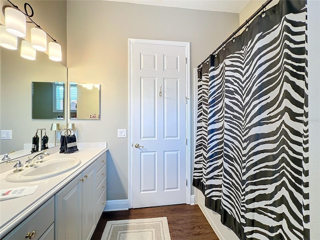 bathroom featuring vanity, wood-type flooring, and a shower with shower curtain