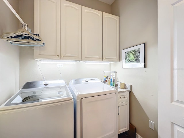 laundry room with cabinets and washing machine and clothes dryer