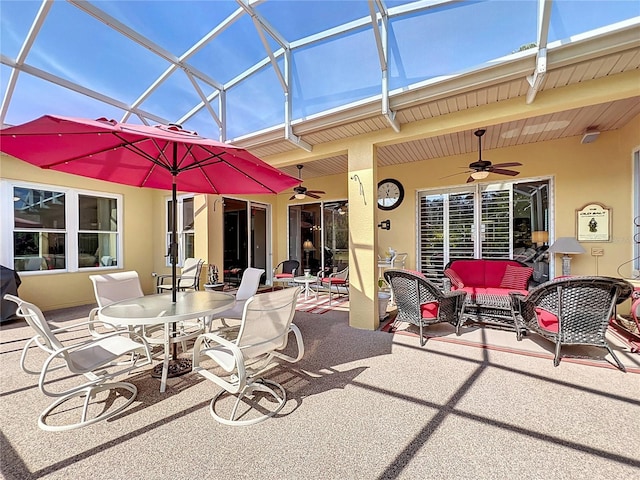 view of patio with a lanai, outdoor lounge area, and ceiling fan