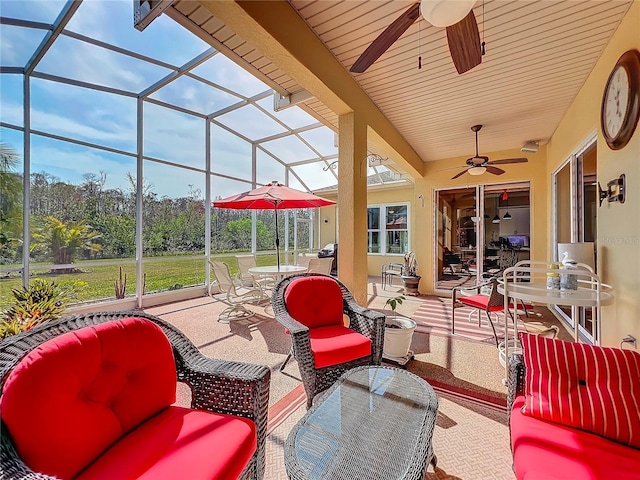 view of patio featuring an outdoor living space, a lanai, and ceiling fan