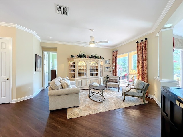 living room with ornamental molding, dark hardwood / wood-style floors, and ceiling fan