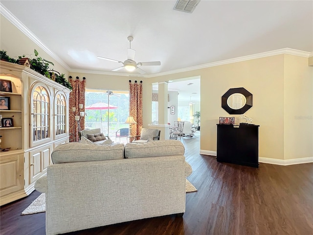 living room featuring crown molding, dark wood-type flooring, and ceiling fan