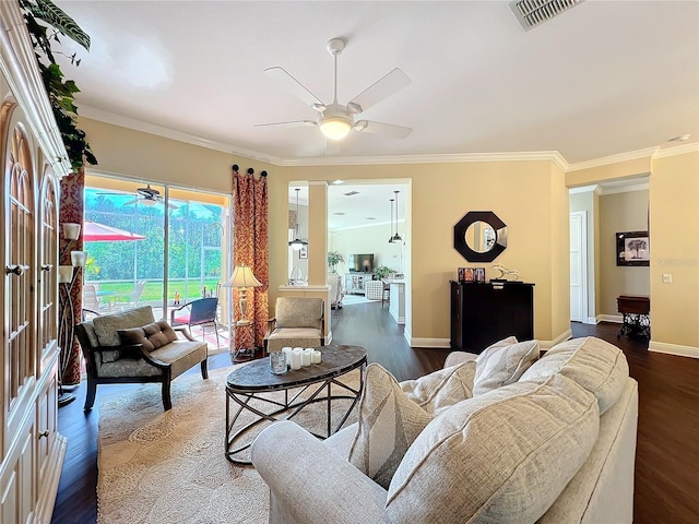 living room with crown molding, dark wood-type flooring, and ceiling fan