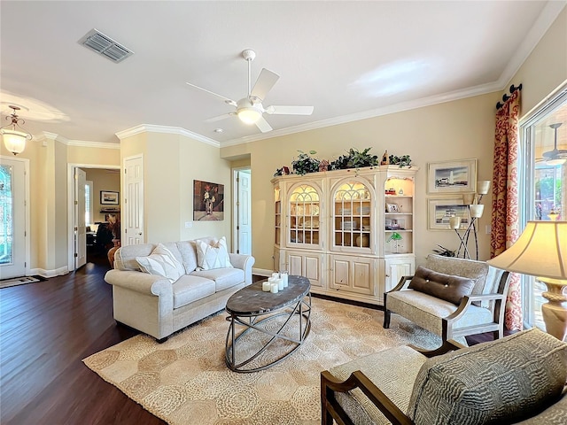 living room with hardwood / wood-style flooring, ceiling fan, ornamental molding, and a wealth of natural light