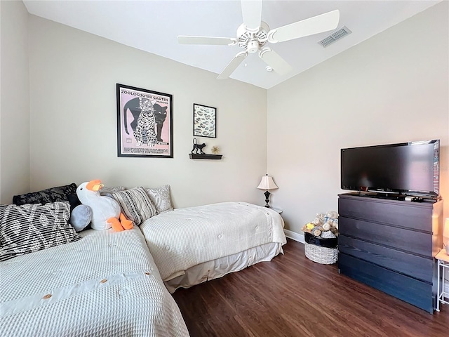 bedroom featuring dark wood-type flooring, ceiling fan, and vaulted ceiling