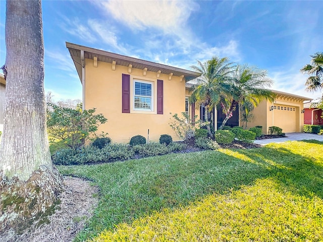 view of front of property with a garage and a front lawn