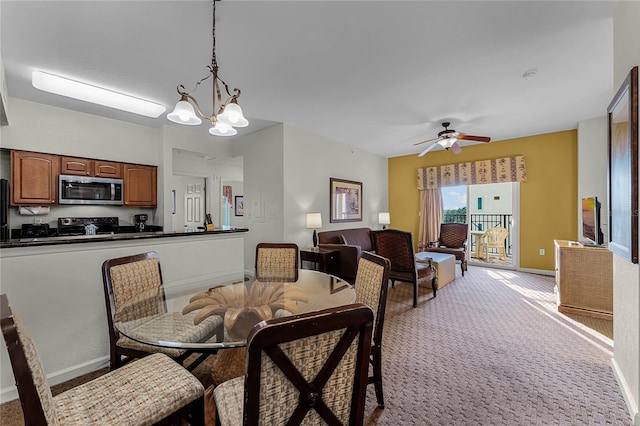 dining area with light colored carpet and ceiling fan with notable chandelier