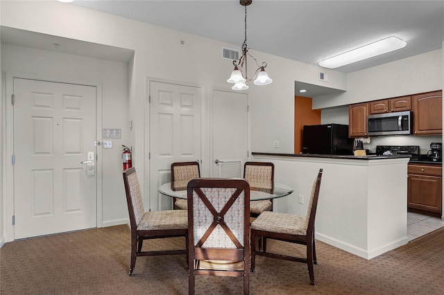 dining room featuring light carpet and an inviting chandelier