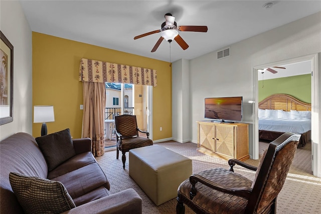 living room featuring ceiling fan and light colored carpet