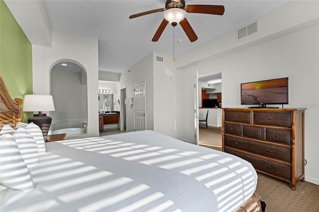 carpeted bedroom featuring ceiling fan and connected bathroom