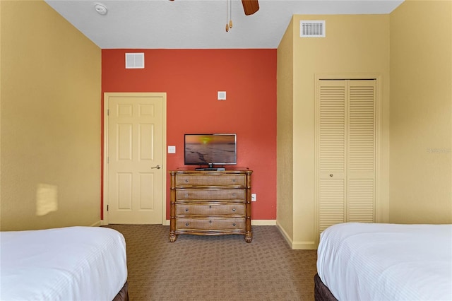 carpeted bedroom featuring a closet and ceiling fan