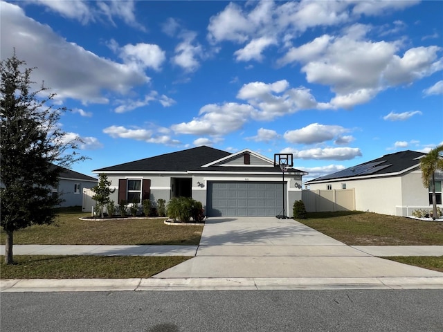 ranch-style home with a garage and a front lawn