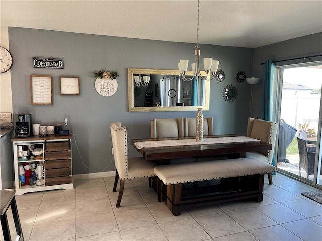 dining space featuring a chandelier and light tile patterned floors