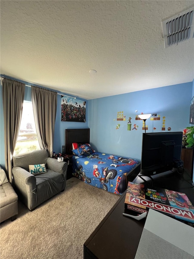 bedroom with a textured ceiling and carpet