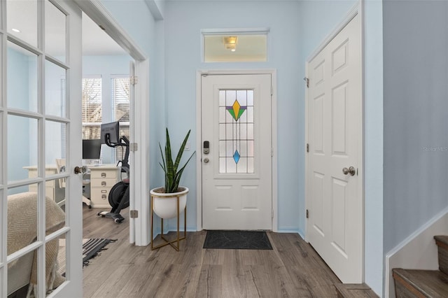 entryway featuring wood-type flooring and french doors