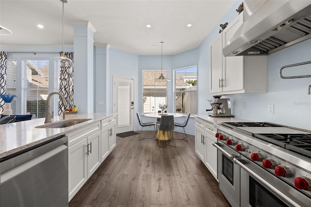 kitchen with stainless steel appliances, island exhaust hood, sink, and white cabinets