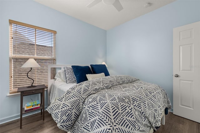 bedroom with dark wood-type flooring and ceiling fan