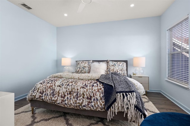 bedroom with dark wood-type flooring and ceiling fan