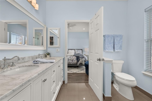 bathroom with tile patterned flooring, vanity, and toilet