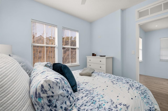 bedroom with hardwood / wood-style floors and ceiling fan