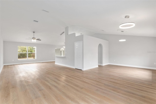 unfurnished living room featuring ceiling fan, vaulted ceiling, and light hardwood / wood-style flooring