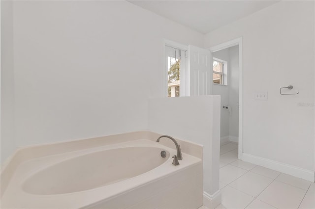 bathroom featuring a relaxing tiled tub and tile patterned floors