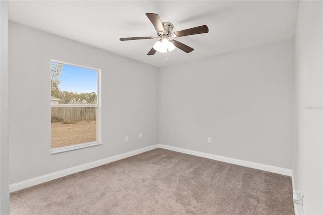 empty room featuring carpet floors and ceiling fan