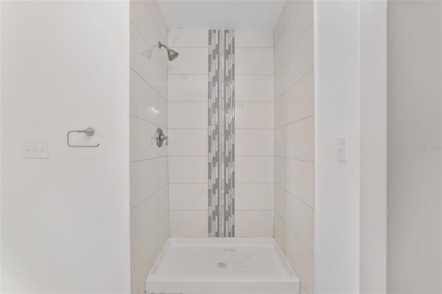 bathroom with tiled shower