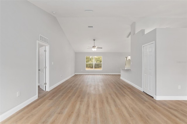 unfurnished living room with ceiling fan, high vaulted ceiling, and light hardwood / wood-style flooring