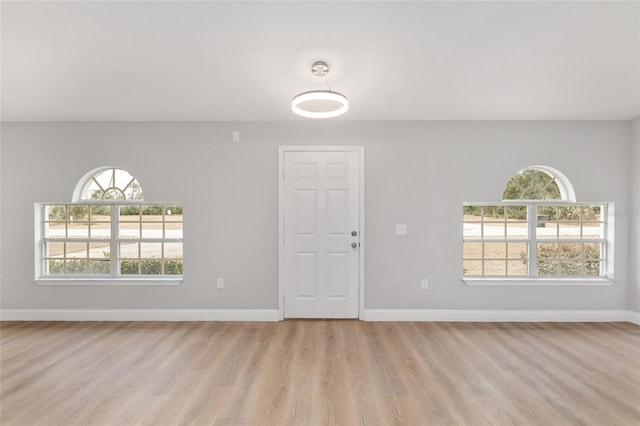 empty room with light hardwood / wood-style floors