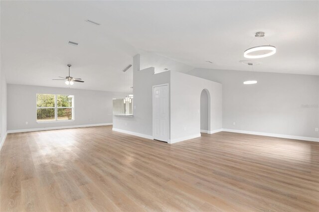 unfurnished living room with vaulted ceiling, light wood-type flooring, and ceiling fan