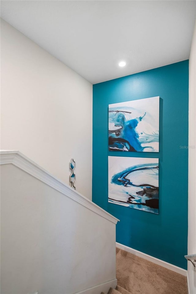 staircase featuring carpet flooring