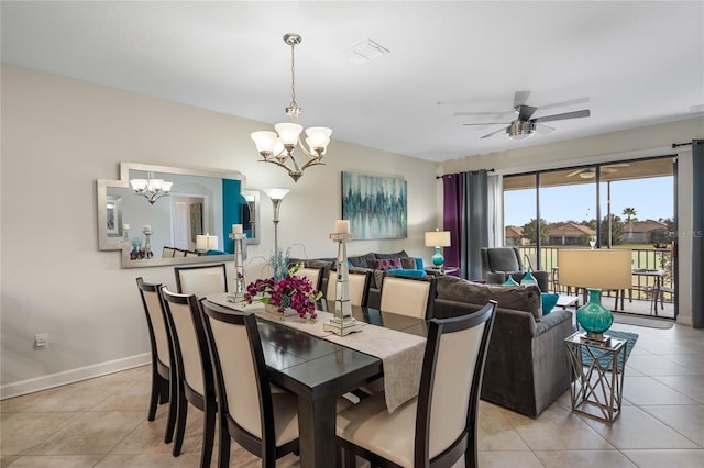 tiled dining space featuring ceiling fan with notable chandelier