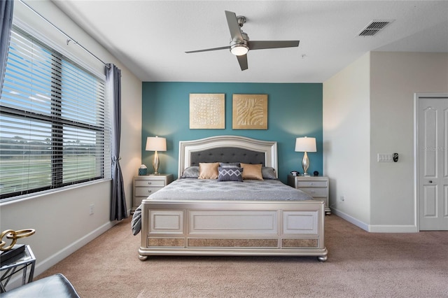 bedroom featuring light colored carpet and ceiling fan