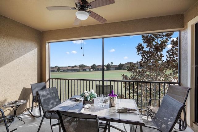 sunroom featuring ceiling fan