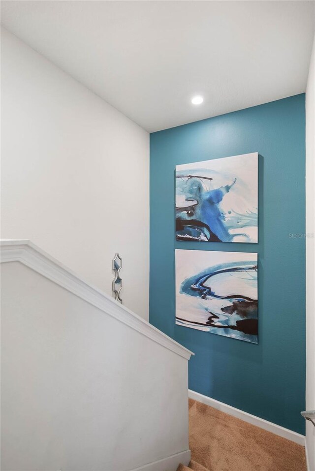 interior space featuring carpet and baseboards