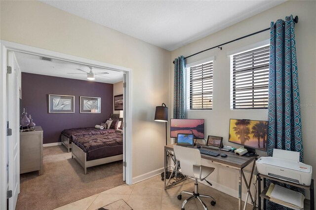 bedroom featuring light tile patterned flooring, light colored carpet, visible vents, and baseboards